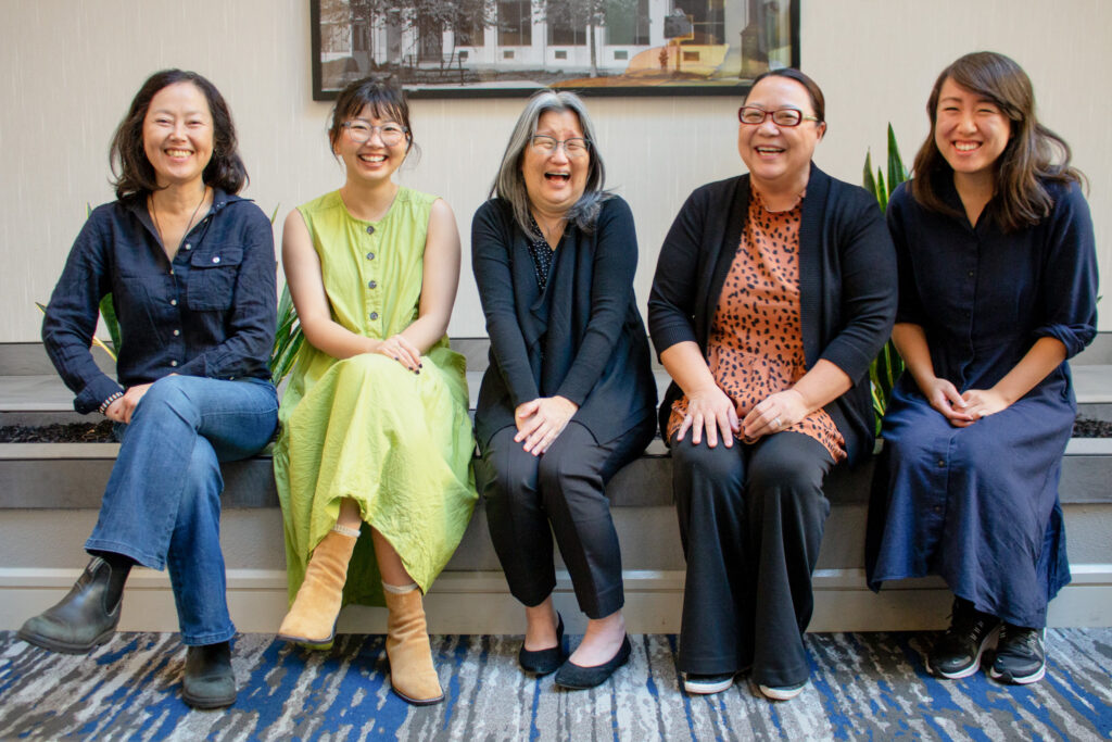 A photograph of EunSook Lee, Jenny Lee, Lori Kodama, Bo Thao-Urabe and Chelsea Trinh seated.