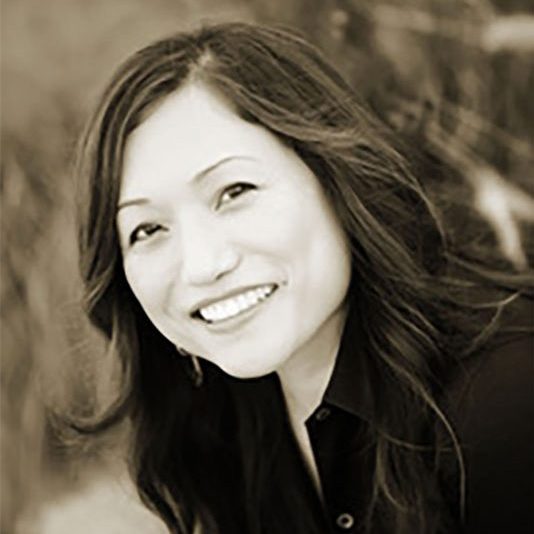 A headshot of the author Claire Jean Kim, smiling at the camera.