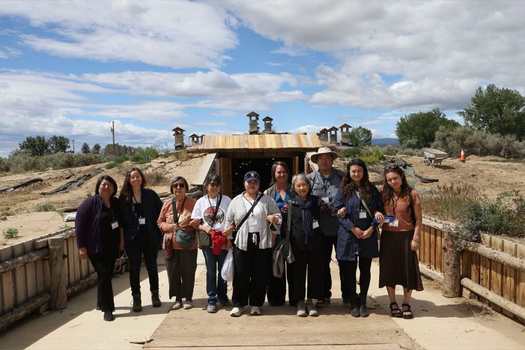 Image of Heart Mountain WWII Japanese American incarcerated Descendants in front of the root cellar in Powell, WY.