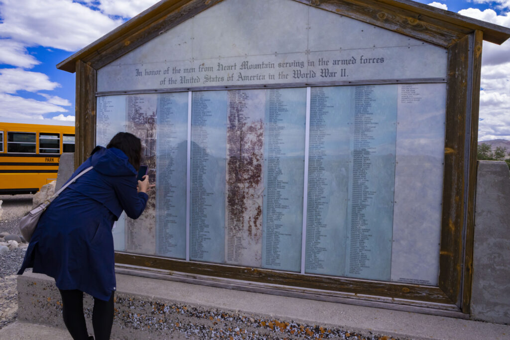 Image of a person looking at the Heart Mountain Honor Roll Monument